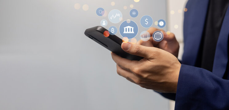 investor businessman hand hold smartphone and access to private banking account application to using system function about checking stock market or transfer money worldwide. for future tech concept