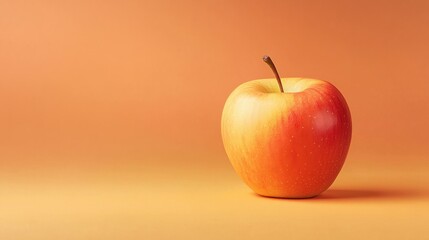 A crisp apple on a smooth pastel orange background.
