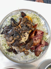 A plate of mushroom and bacon.