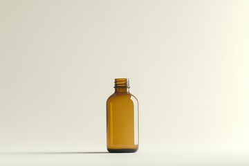 Amber glass bottle on minimalistic background.