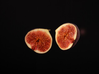 Fig cut in half on a black background