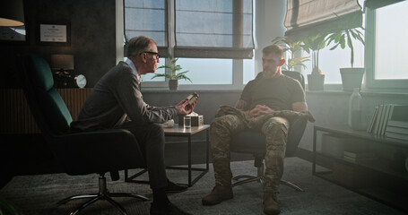 Professional therapist conducts psychotherapy session or psychological post war rehabilitation for...