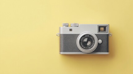 Fototapeta premium A vintage camera centered on a pastel yellow background.