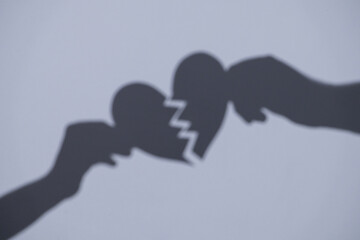 A broken heart. A guy and a girl holding a broken heart