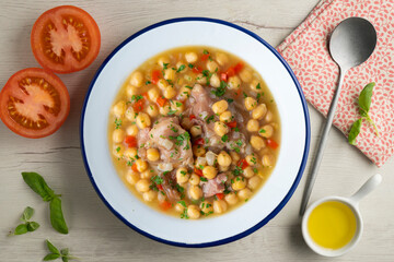 Chickpea stew with pig trotters. Top view table with  decorations.