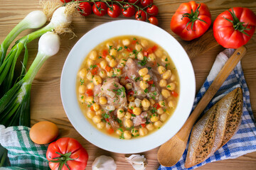 Chickpea stew with pig trotters. Top view table with  decorations.