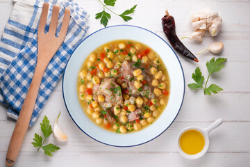 Chickpea stew with pig trotters. Top view table with  decorations.