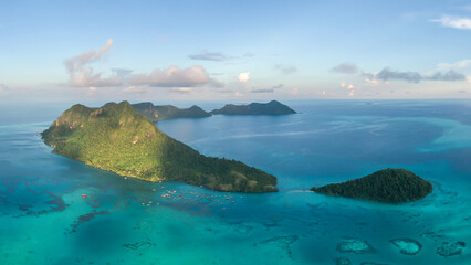 Aerial view of Bohey Dulang island panorama, beautiful blue lagoon and coral reef.