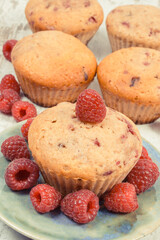 Fresh baked muffins with raspberries and chocolate. Delicious dessert for different occasion