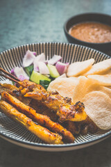 Chicken Satay served with Prawn crackers, onions, cucumber, spicy peanut sauce.