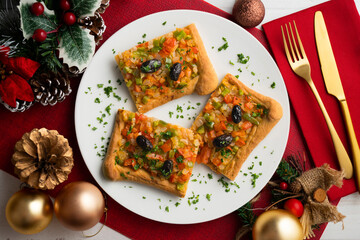 Coca de trampo mallorca with vegetables. Top view table with christmas decorations.