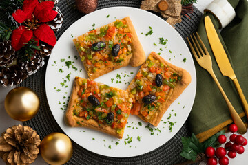 Coca de trampo mallorca with vegetables. Top view table with christmas decorations.