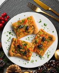 Coca de trampo mallorca with vegetables. Top view table with christmas decorations.