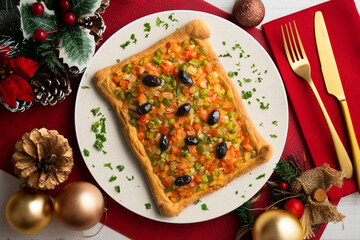 Coca de trampo mallorca with vegetables. Top view table with christmas decorations.