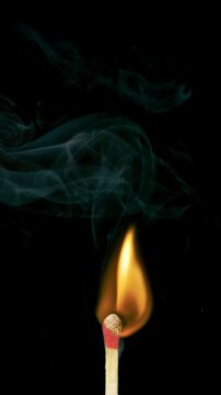 Super Slow motion macro shot of wooden match igniting.