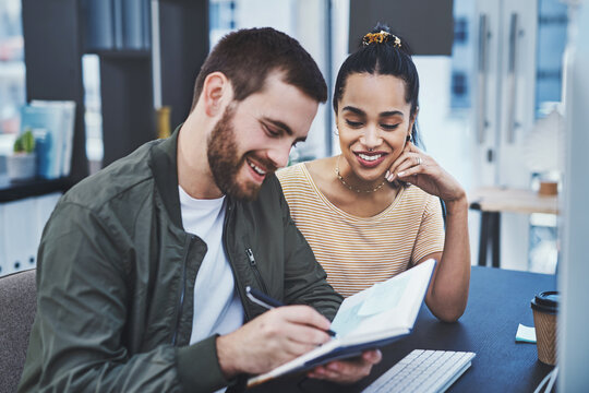 Collaboration, planning and writing with business people in creative workplace for project management. Agenda, diary or notebook with designer man and woman in workplace for meeting or teamwork