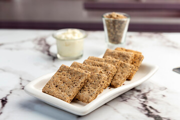 Homemade natural vegetarian and vegan oat and seed cookies on kitchen table with ingredients 