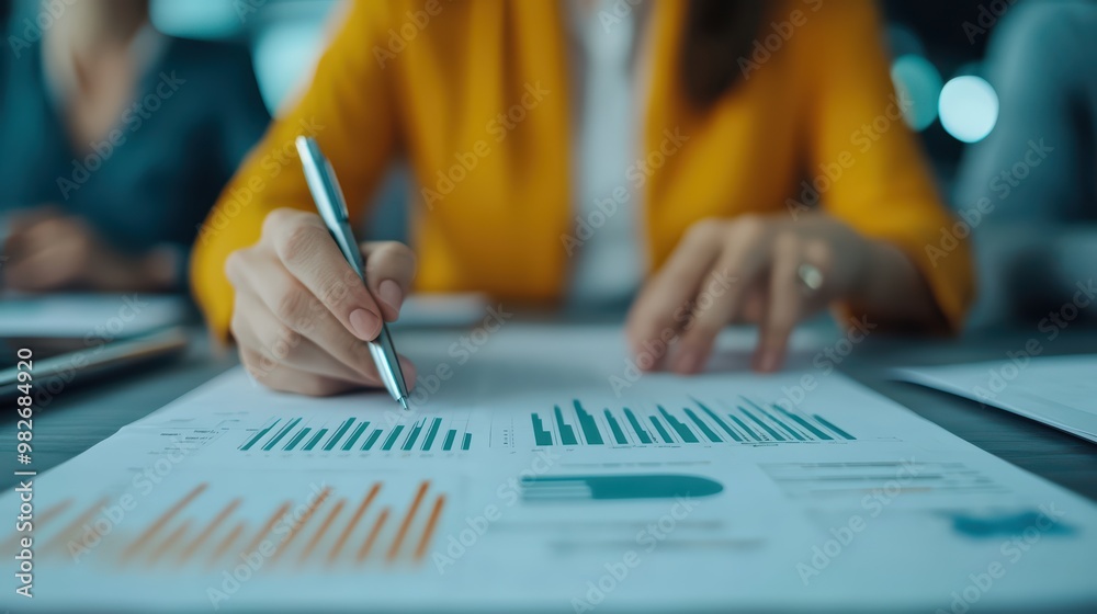 Poster close-up of a person analyzing charts and graphs on a document. focus on data interpretation and bus