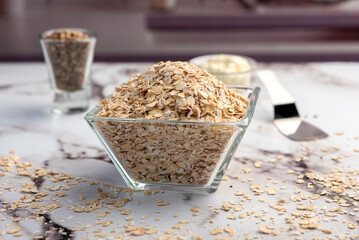 Homemade natural vegetarian and vegan oat and seed cookies on kitchen table with ingredients 