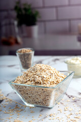 Homemade natural vegetarian and vegan oat and seed cookies on kitchen table with ingredients 
