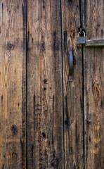 rustic, weathered wooden door with a metal handle natural texture background, aged wood grain