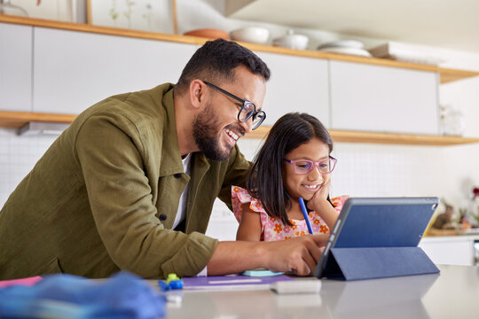Father helping his little girl with homework on digital tablet