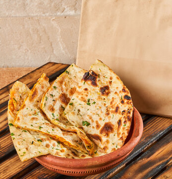 aaloo parantha in a bowl with food delivery packaging