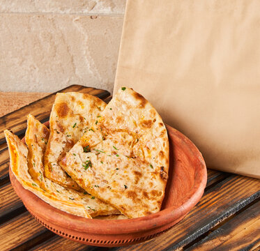 paneer parantha in a bowl with food delivery packaging