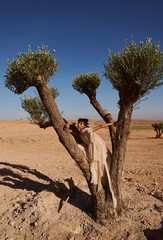 Fashion shooting in the desert, professional model and stylish Muslim clothing.