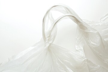A close-up view of a transparent plastic bag, showcasing its flexible shape and delicate texture against a minimalist background.