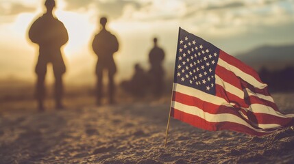 American flag in focus with soldiers standing in the background at sunset. Symbolic for Veterans Day or Memorial Day.