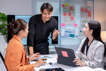 Asian businesspeople discussing and brainstorming, working together in the office