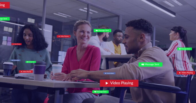 Image of social media icons with texts over diverse colleagues discussing work in office