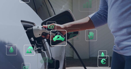Image of eco icons and data processing over caucasian man charging electric car