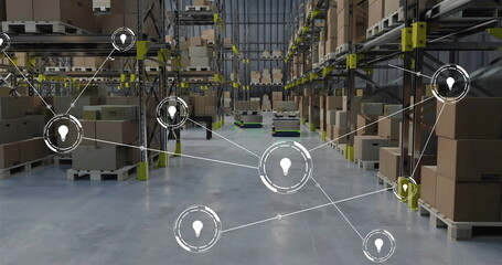 Image of network of connections with icons over robots working in warehouse