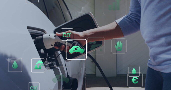 Image of eco icons and data processing over caucasian man charging electric car