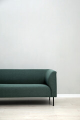 Comfortable sofa near light grey wall indoors, space for text