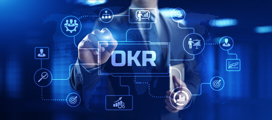 OKR Objectives key results. Businessman pressing button on screen.