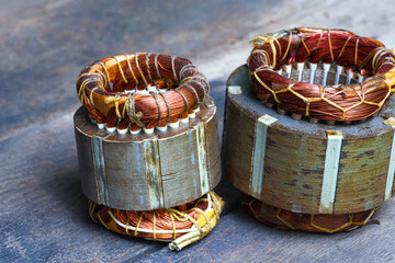 Electric motor stator with winding coil on  wood table .