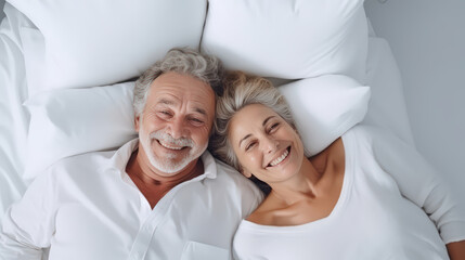 A Portrait of happy senior couple lying on bed in room, Pensionist, retirement.