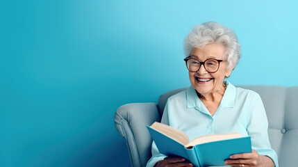 A portrait of cheerful mature lady professor hold book material story isolated over blue color background, retirement and pensionist