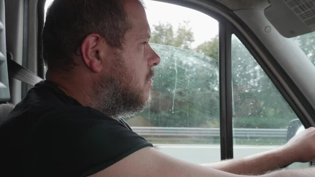A truck driver with short hair feels extremely tired while driving. His eyes close as he nods off, but he wakes up suddenly before it's too late, narrowly avoiding a disaster.