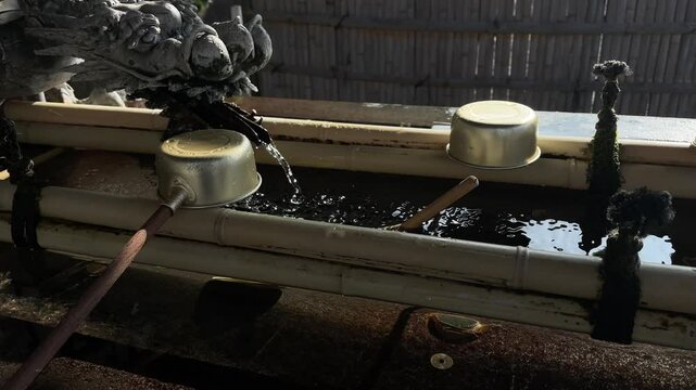 Water scoops in the shrine in Japanese temple Naritasan