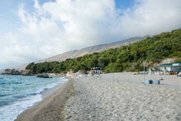 Very beautiful coastline on the Ionian Sea in Albania. The beach with fine sand in the mountains of Albania. Vacation at the sea.