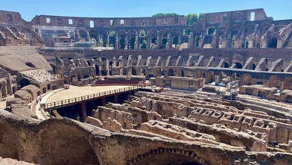 Interior of the Colosseum in Rome Italy on a sunny day, showcasing its ancient Roman architecture and archeological significance. A must-see European landmark for history and travel enthusiasts