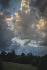 Fototapeta premium sunset over the field in summer with dramatic sky in Czech Republic, rural view