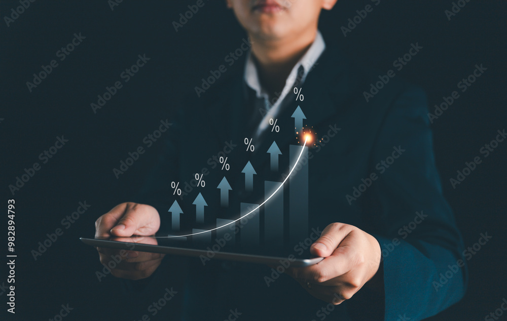 Wall mural businessman using tablet analyzing sales data and economic growth graph chart. business growth strat