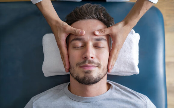Holistic Facial Therapy Session for Men Promoting Balance and Relaxation with Gentle Hand Movements in a Calm, Therapeutic Spa Environment to Revitalize the Face and Skin