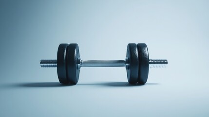 pair of dumbbells placed on a plain, unobtrusive background, highlighting their shape and material