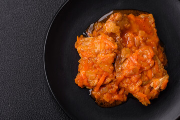 Sliced fish in tomato sauce with salt and spices